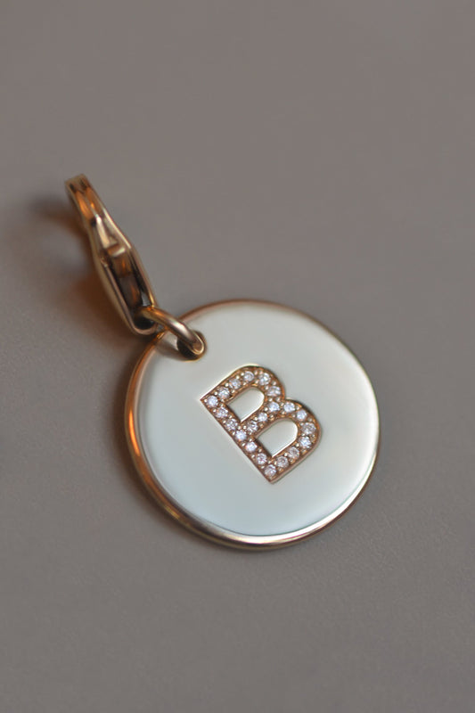 ÉMINENCE  A solid 9ct yellow gold pendant, flush set with natural round brilliant cut white diamonds to form your pet’s initial.