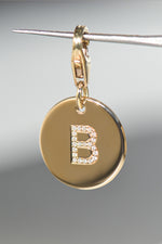 EMINENCE by PAWVÉ. A solid 9ct yellow gold pet pendant with flush set natural white diamonds to form "B" initial. linked to a 9ct yellow gold clasp.
